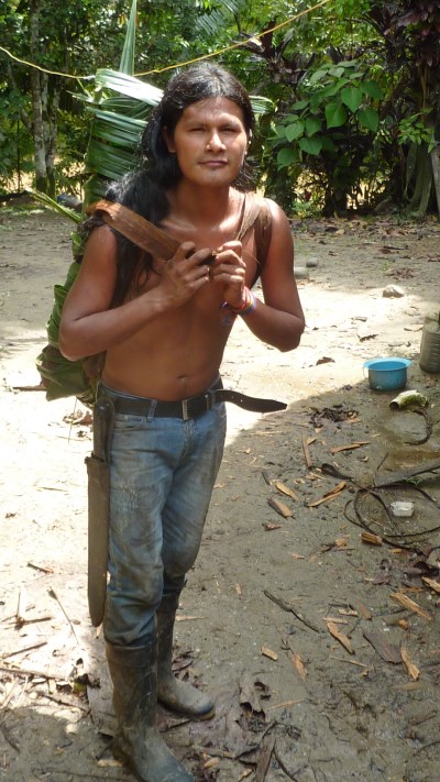 Jose Luis carrying yucca in a backpack made of leaves